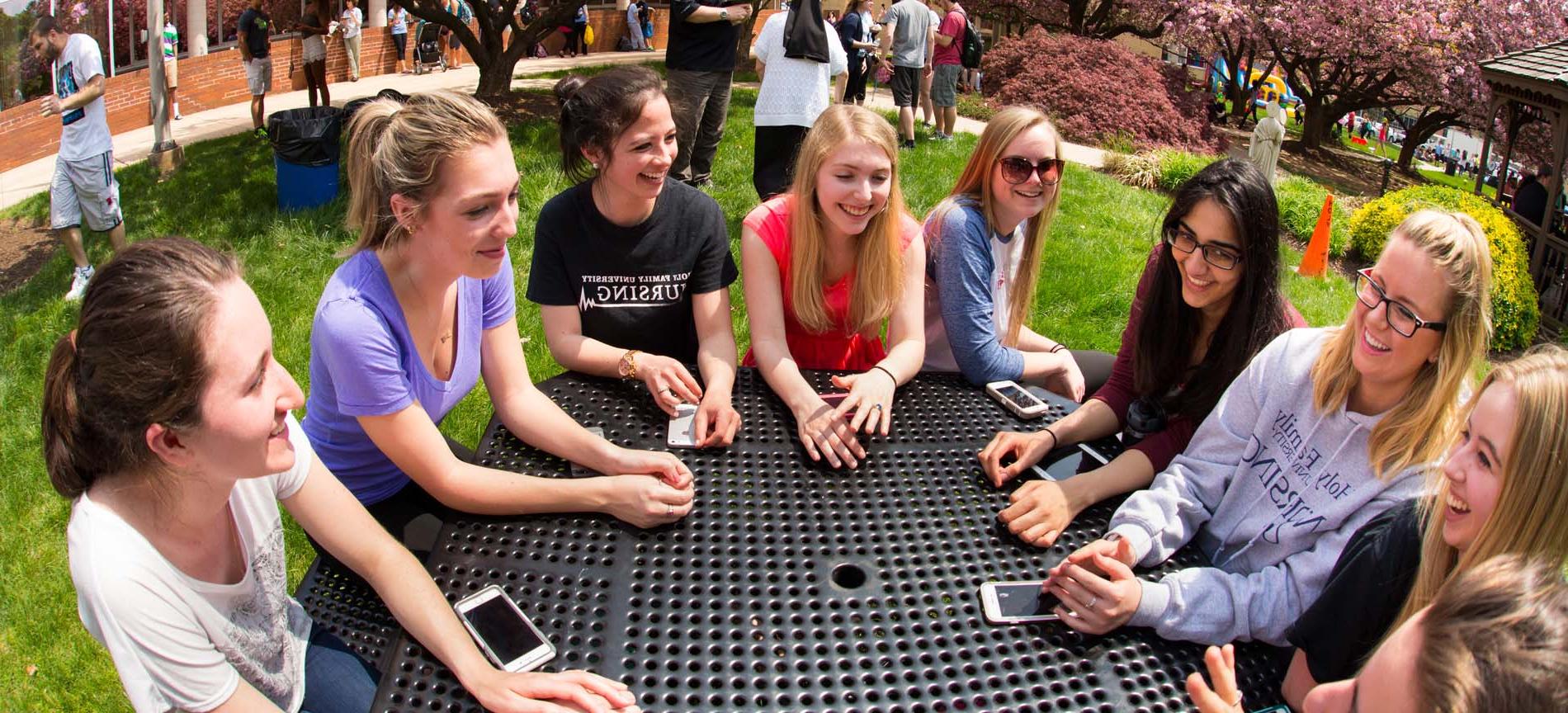 Girls sitting outside at a round table